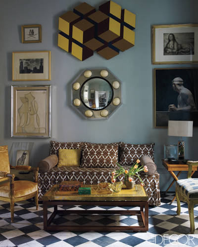 In the sitting room, a steel-and-ostrich-egg mirror hangs above a sofa upholstered in a 1960s David Hicks fabric; the Jacob Frères armchair is covered in a Rubelli velvet, and the cocktail table is from the '70s. The artworks include paintings by Xavier Vilató, bottom left, and José María Yturralde, center, and a Josep Maria Subirachs engraving and Miguel Macaya painting, right.