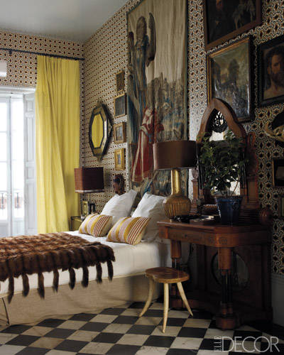 The master bedroom includes a tapestry by Rubens, a 17th-century octagonal mirror, and a 19th-century neo-Gothic dressing table; the wallpaper was designed by Castillo.