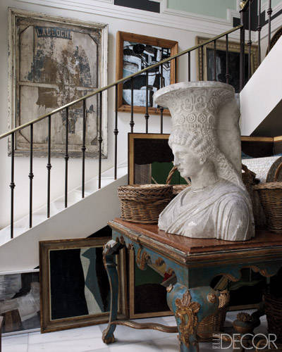 A plaster bust from the École des Beaux-Arts in Paris is displayed in the stairwell on an 18th-century table from Burgos Cathedral.