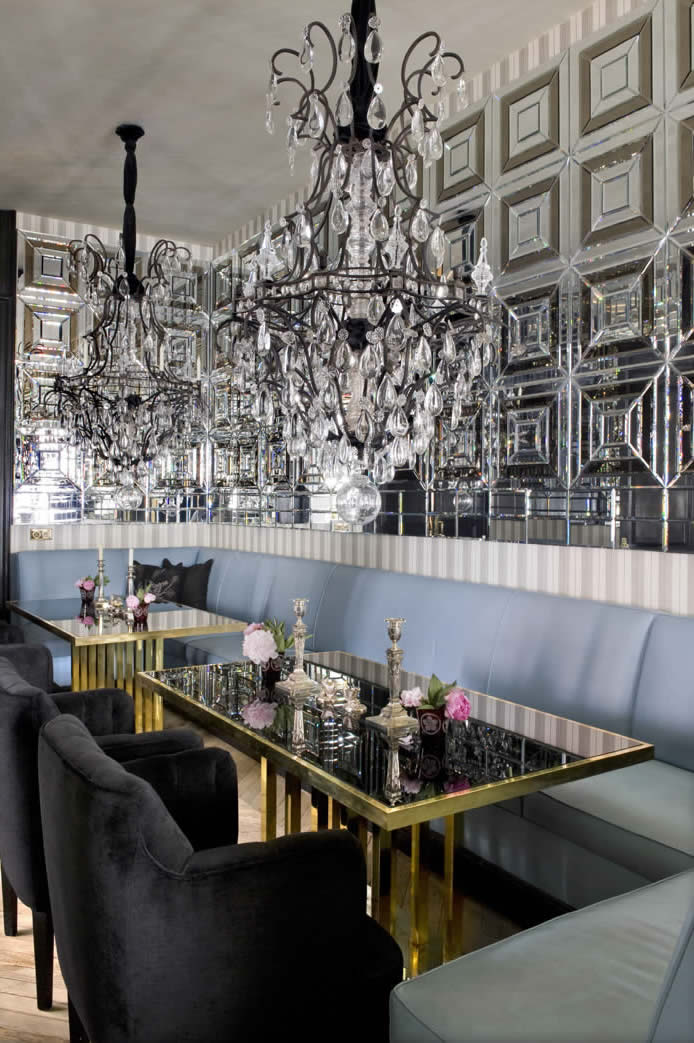 The armchairs, tables and mirrors in the glamorous dining room are by Castillo, and the light fixtures are 19th-century.