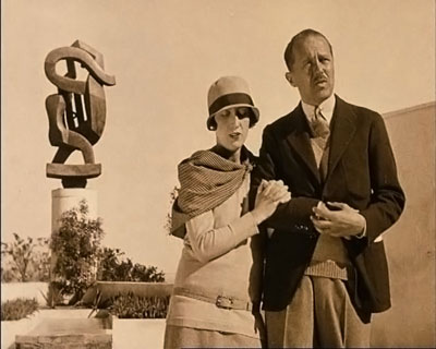 The couple standing before the sculpture designed by 