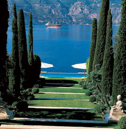 An allée of cypress trees sloping down a hill towards water's edge at Villa Fiorentina was the work of renowned British landscaper Russell Page.