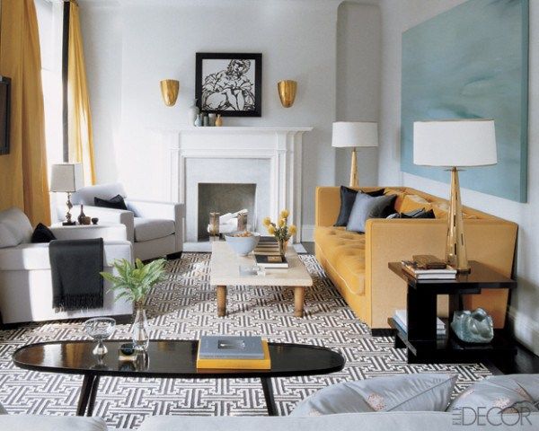     Steven Gambrel punctuated the black-and-white color scheme of this Manhattan living room with a golden yellow sofa. Photo by Simon Upton.