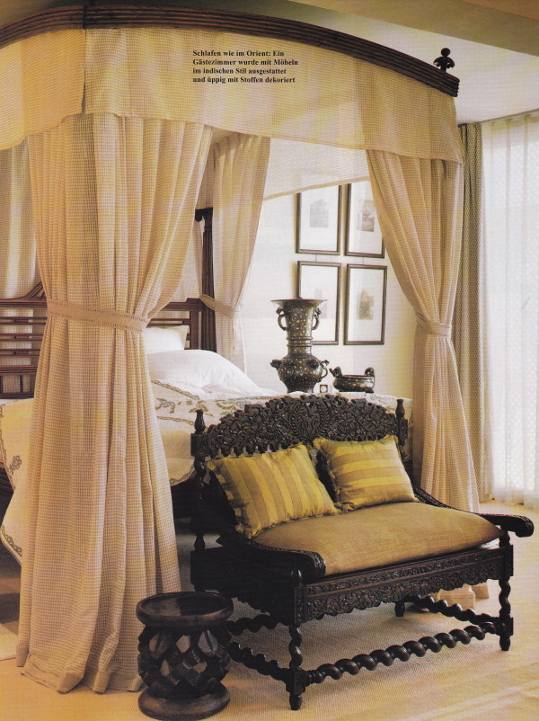 A guest bedroom is decorated with Anglo-Indian furniture.
