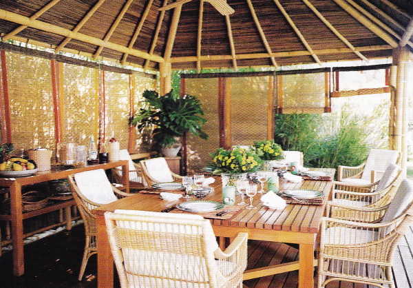 The bamboo outdoor dining terrace is decorated with rattan furniture.