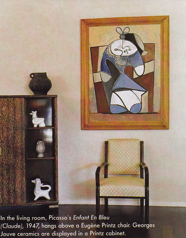 In the living room, Picasso's Enfant En Bleu (Claude), 1947,hangs above a Eugène Printz chair. Geroges Jouve ceramics are displayed in a Printz cabinet.