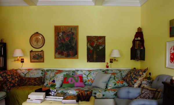 Jeffrey Bilhuber selected a chiffon yellow for the walls as a background for the floral pattern on blue ground covering the sofa. From The Way Home.