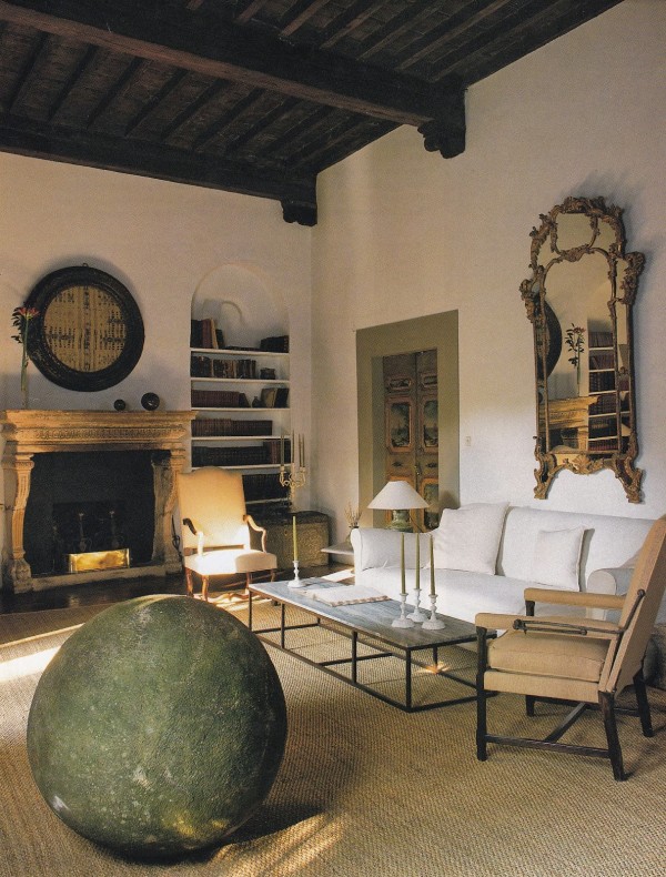 A gilt Italian Rococo mirror punctuates a wall in the living room of the Labèque sister's palazzo apartment in Tuscany designed by Axel Vervoordt. Photo by Simon Upton for AD.