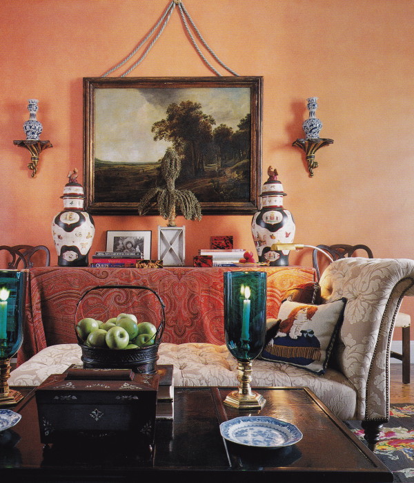 An orange painted library decorated by Mario Buatta. Architectural Digest; photo by Scott Frances.