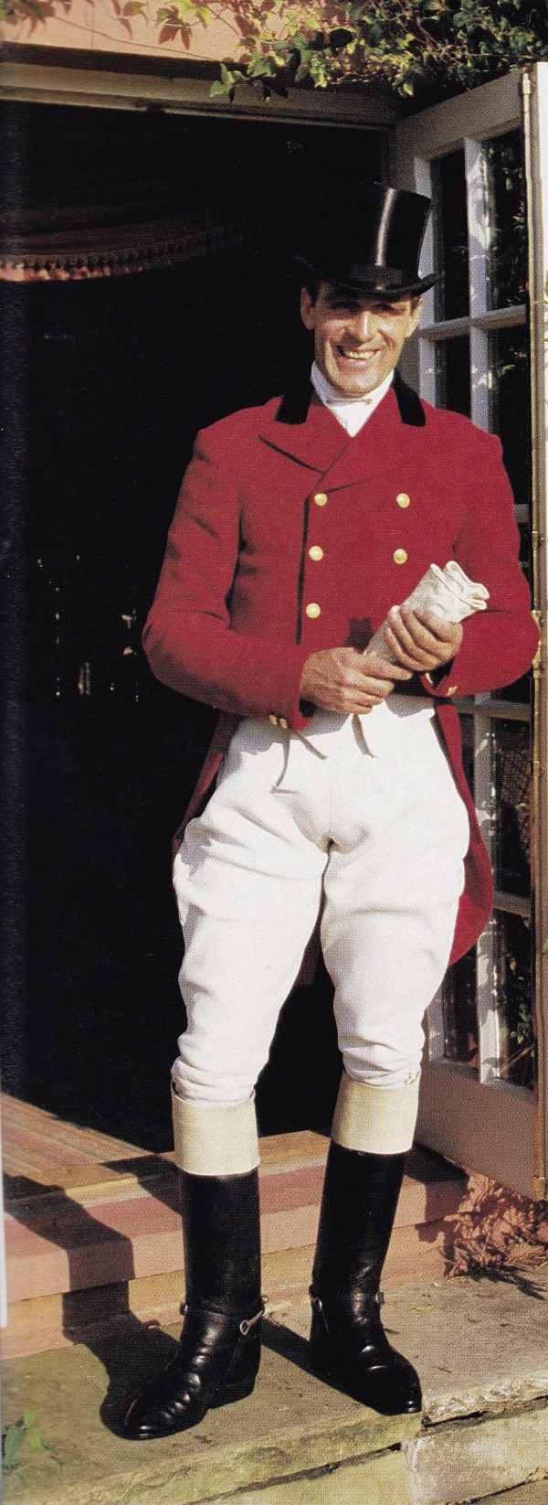 Robin Smith-Ryland, then secretary of the Warwickshire  Hunt, dressed in a swallow-tailed coat of hunting pink with Warwickshire Hunt buttons, buckskin breeches, and a black silk hat outside his 16th-century farmhouse in Sherbourne. HG; March 1989. Photo by Oberto Gili.