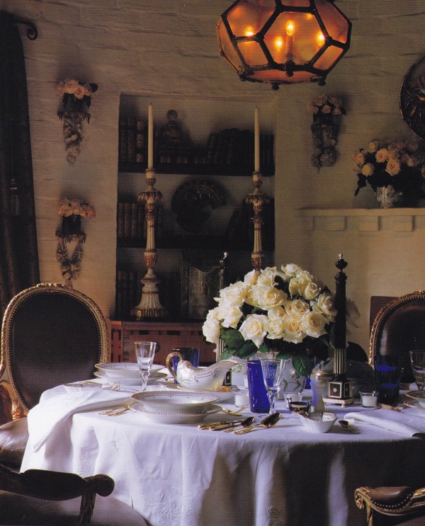 The setting of Craig Wright's dining room in his previous West Hollywood home is dripping with romance: a table straight from an Italian villa is elegantly set with starched linens, fine china, crystal and vermeil flatware before a fireplace set with vases of flowers and wall-mounted vases filled with roses flanking a niche holding elaborate Italian candlesticks. From Los Angeles: A Certain Style by Pilar Viladas. Photo by John Vaughan.