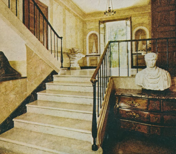 The entry hall with a view toward the front door and one of Emilio Terry's covetable plaster and marble consoles.