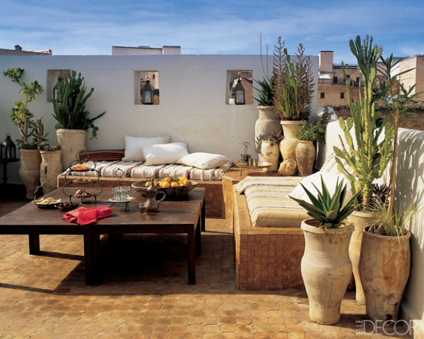 On the roof terrace of Stephen di Renza’s vacation house in Fez, Morocco, mattresses are placed on tiled platforms and covered with weavings traditionally worn by shepherds. The tables are made of lacquered iron, and vintage handthrown jars, which originally stored food, now hold cacti and other indigenous plants. Elle Decor; April, 2006.
