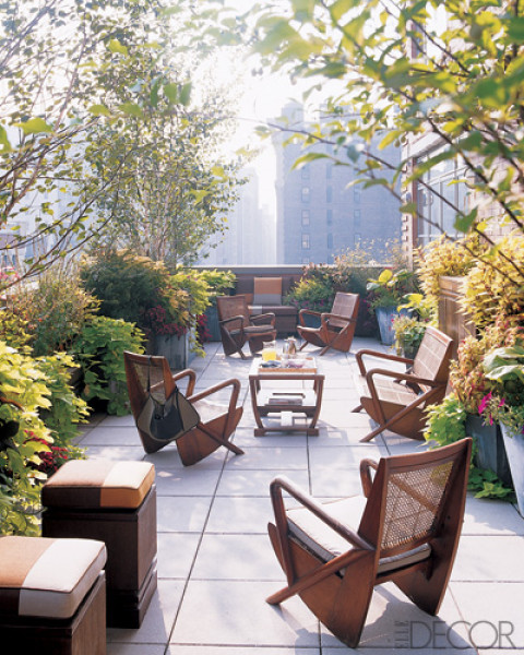 Tom Fox and Joe Nahem placed organic, rustic modern outdoor furniture on the lushly planted terrace of a New York penthouse apartment. Photo by Pieter Estersohn.
