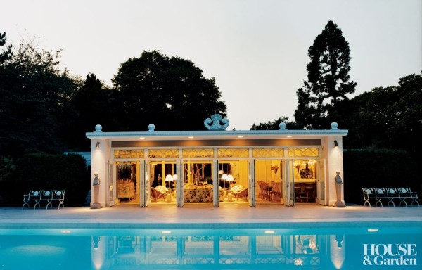 Carl D'Aquino and Francine Monaco restored this pool pavilion in Allentown, Pennsylvania, taking their cue from Max Hess's original vision of mid-century Hollywood glamour. At dusk, the glowing interiors—revealing intricate beaded fretwork and lavish furnishings—are reflected in the water. Photo by Simon Watson.