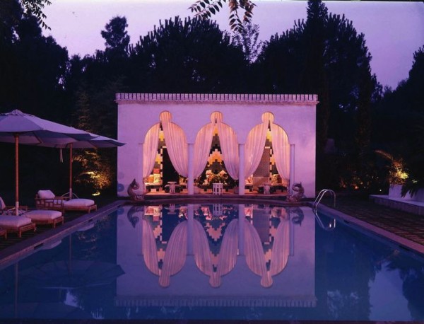 1974: Tessellating Neapolitan ceramic tiles offer a graphic backdrop between the Moorish archways of the pool house. The Roman pool is framed by Baroque fish. Photographed by Horst P. Horst, Vogue, August 1974. 